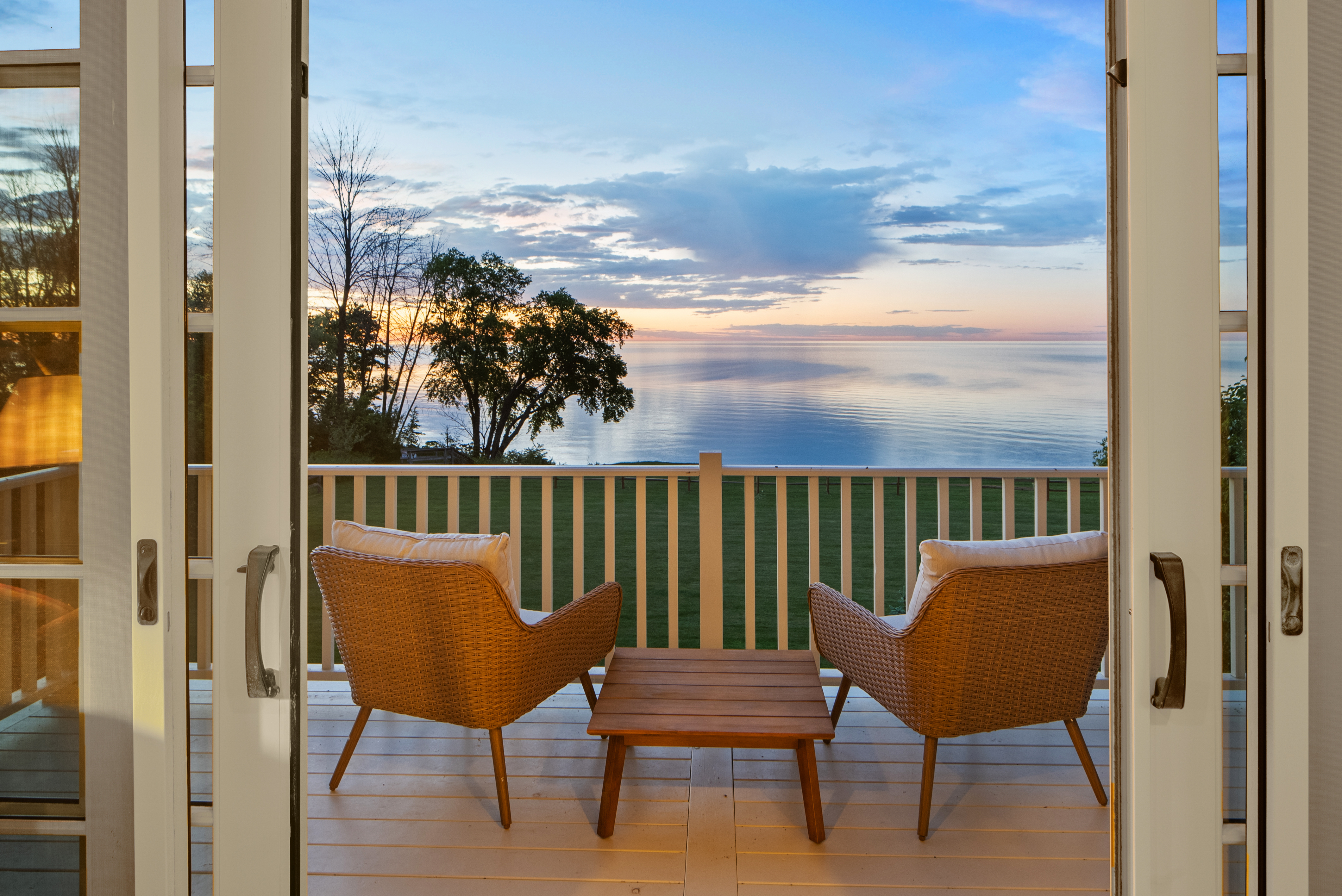 Private balcony overlooking Lake Michigan at sunset at Evergreen Manor