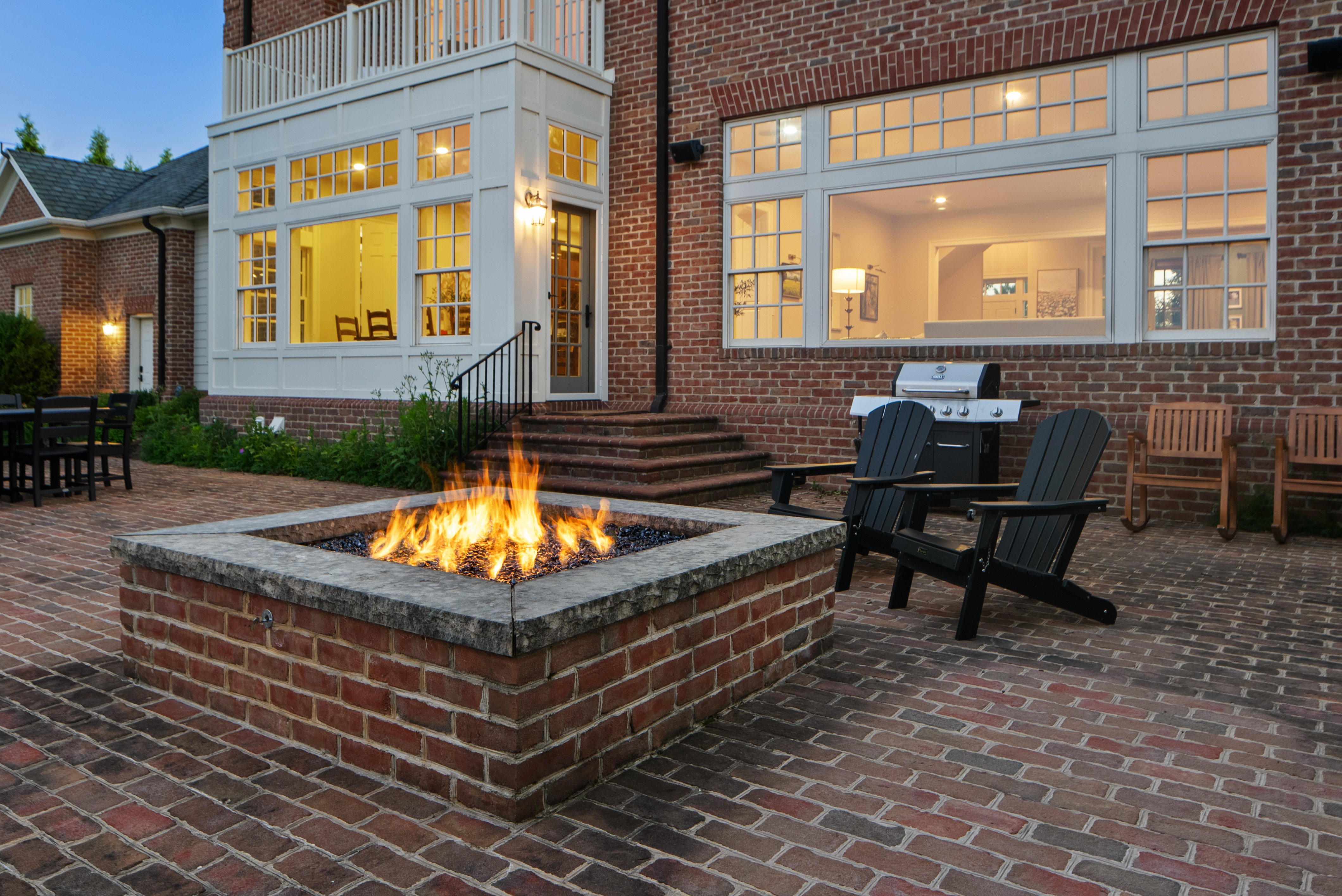 Gas fire pit fully lit at dusk at Evergreen Manor Wisconsin