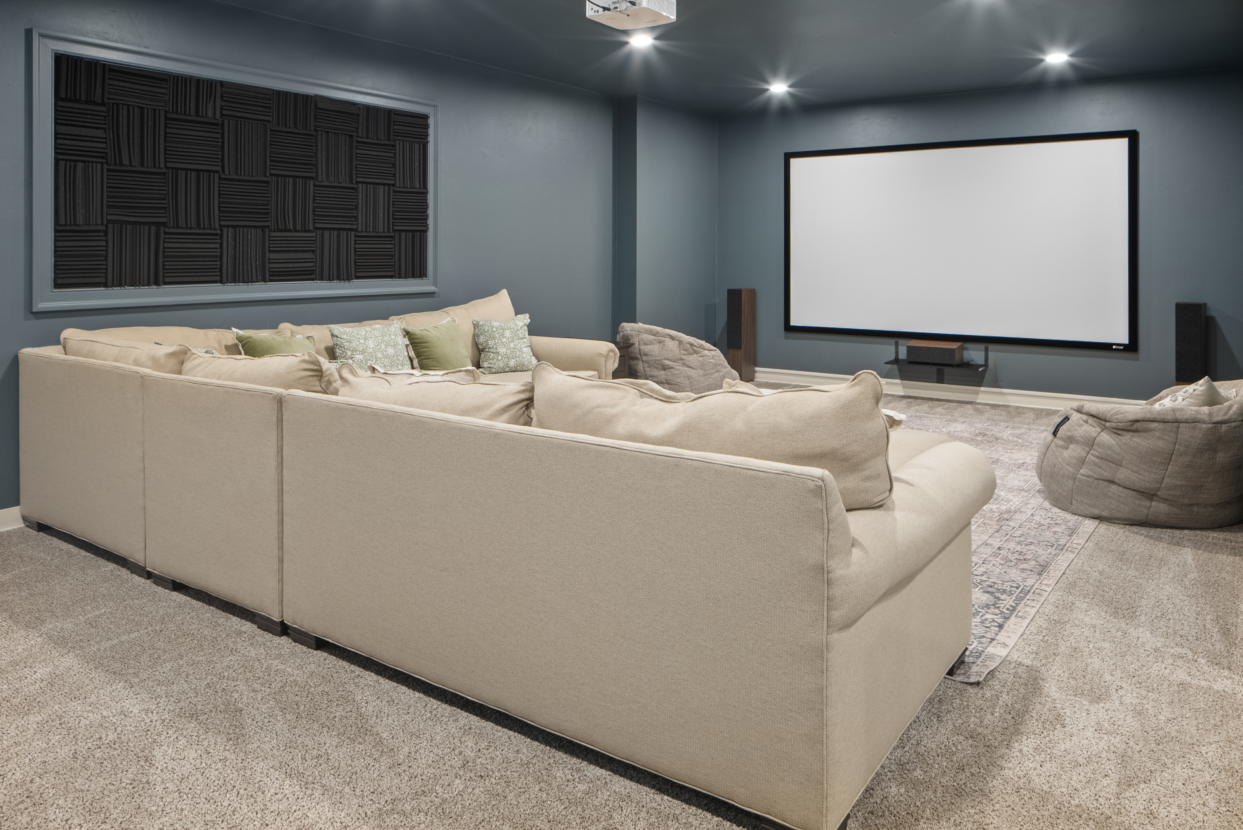 Family theater room with projector and sectional at Evergreen Manor Wisconsin